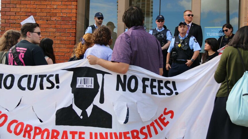 Protestors carry banner saying: No cuts! No fees! No corporate universities.