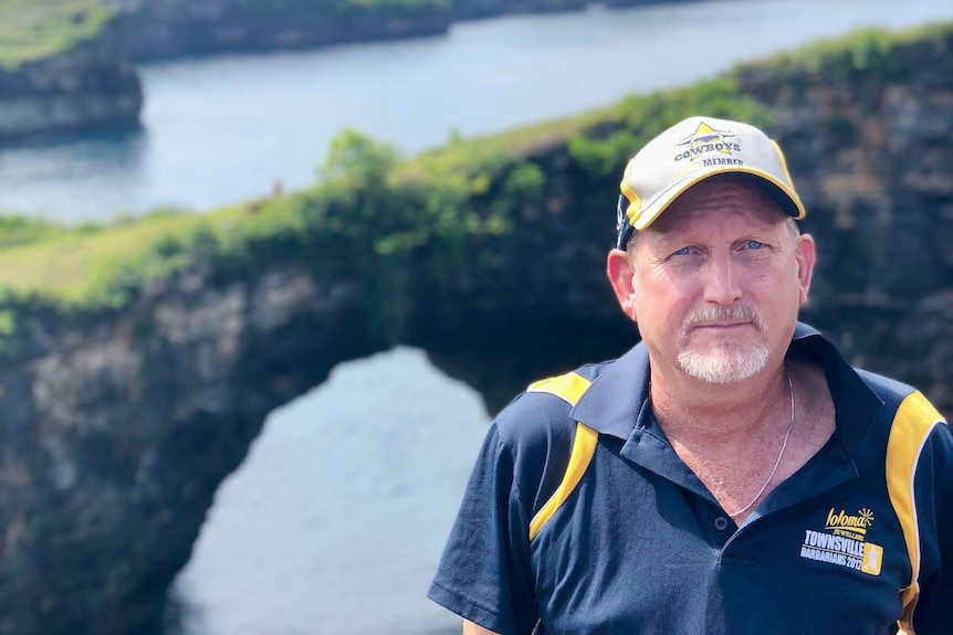 man in hat and polo shirt at overseas location