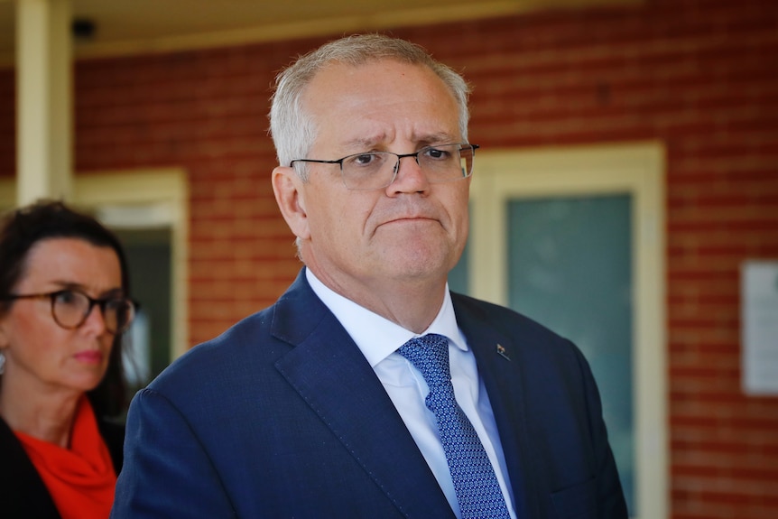 morrison looks downcast while he's listening to a question