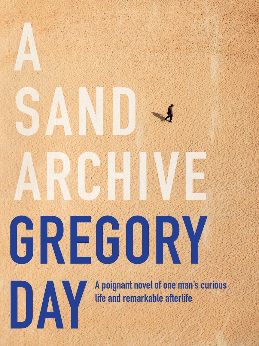 The book cover shows a birds eye view of a man alone on the sand.