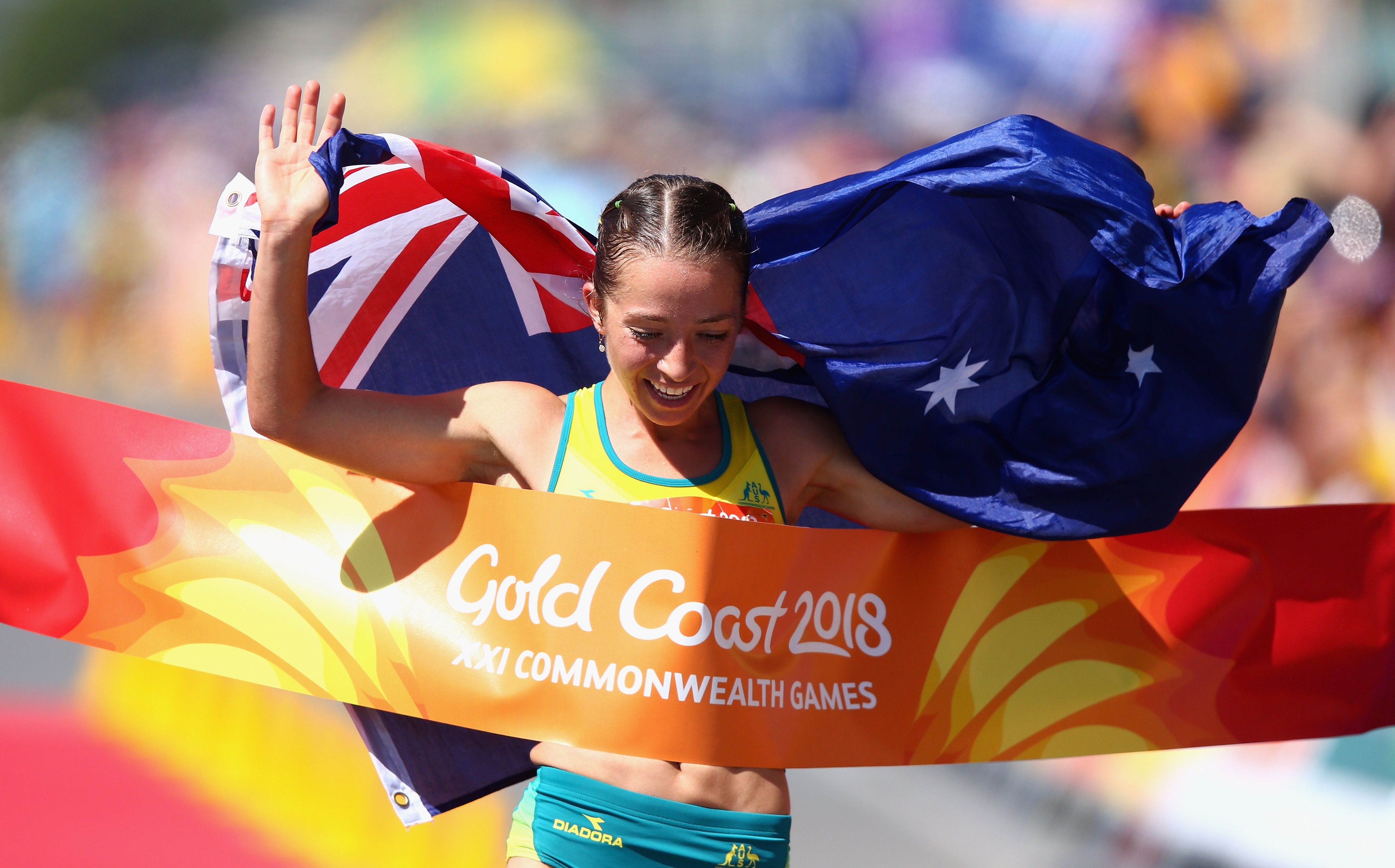 Jemima Montag crosses the line as she celebrates her gold medal in the Women's 20km Race Walk Final at Gold Coast, 2018.