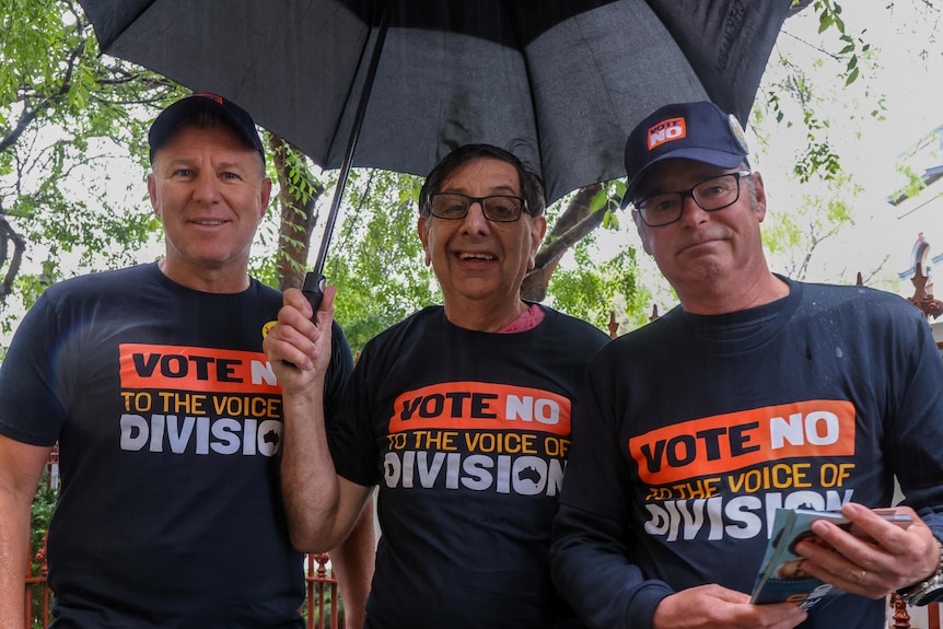 Craig Berger and two other men in 'VOTE NO TO THE VOICE OF DIVISION'  t-shirts.