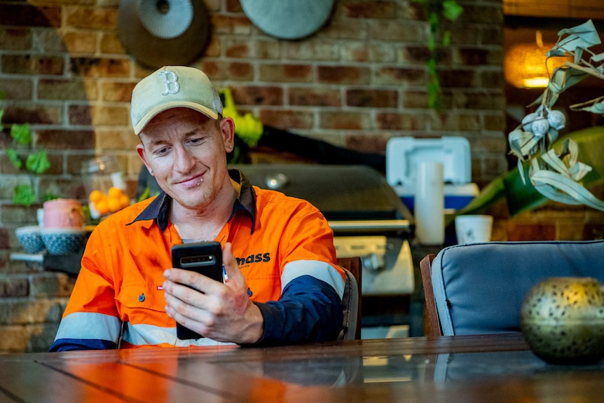 A man looking endearingly at a phone