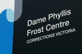 A close up of a sign that reads 'Dame Phyllis Frost Centre, Corrections Victoria'.