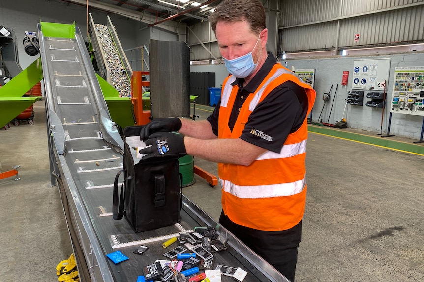 a man in high vis with batteries