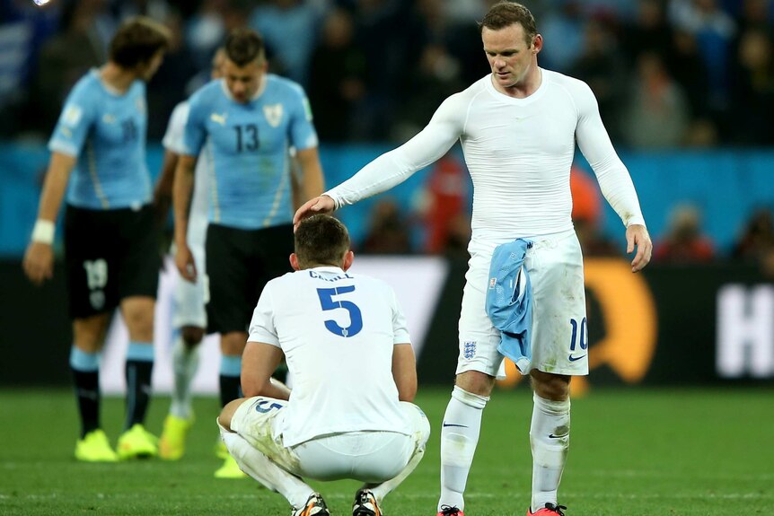 Rooney consoles Gary Cahill after Uruguay loss