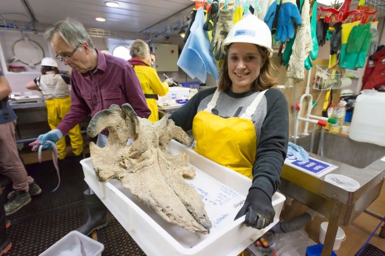 Deakin University researcher Jasmin Bursic with a whale skull found in Australia's eastern abyss in June 2017