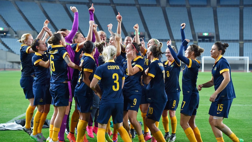 The Matildas celebrate Olympic football qualification after they beat North Korea in Osaka.