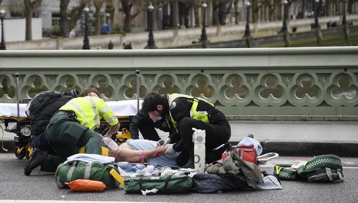 Paramedics help the wounded people along Westminster Bridge in London on March 22, 2017