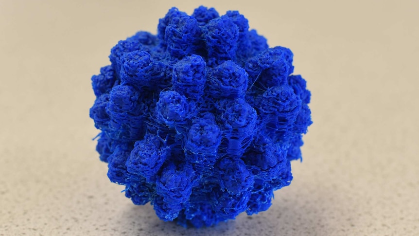 A scaled-up model of a virus particle made of bright blue plastic