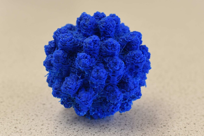 A scaled-up model of a virus particle made of bright blue plastic