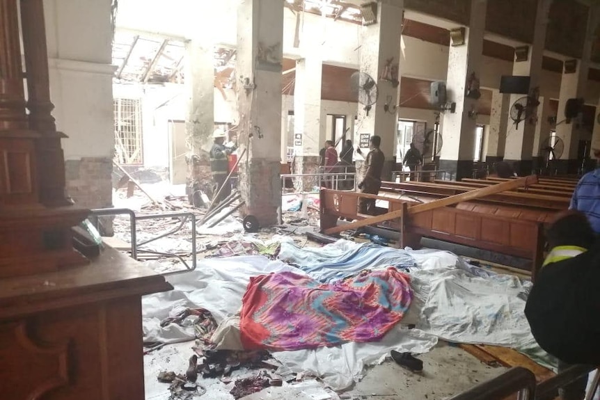 An empty building with a debris strewn across the floor.