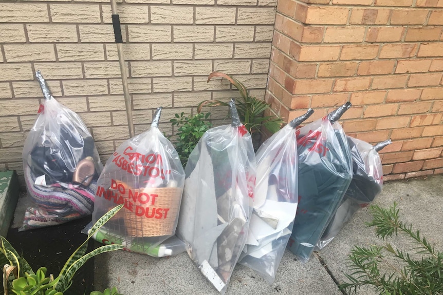 Bags of items affected by asbestos dust