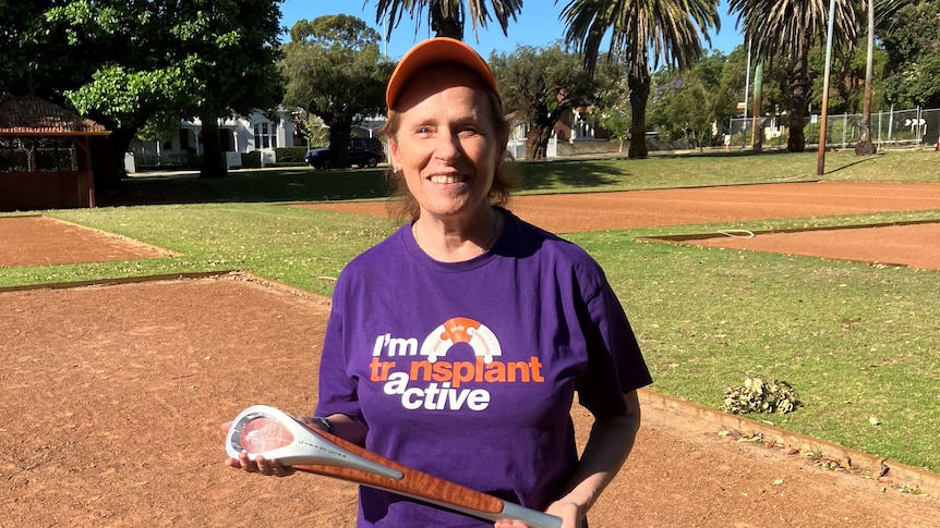 Lynette holds the World Transplant Games torch