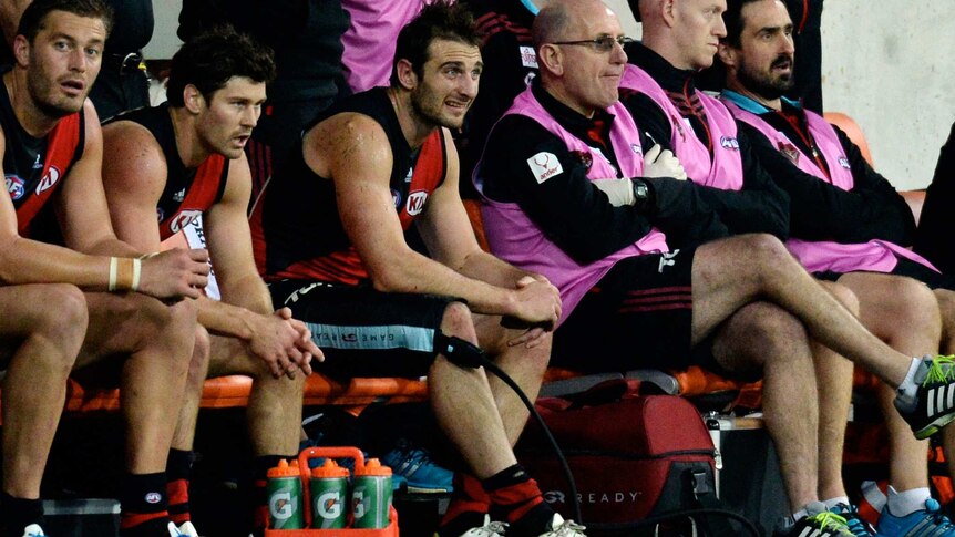 Jobe Watson looks on with strapped thigh