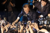 South Korea's presidential candidate Moon Jae-in of the Democratic Party is greeted by supporters in Seoul.