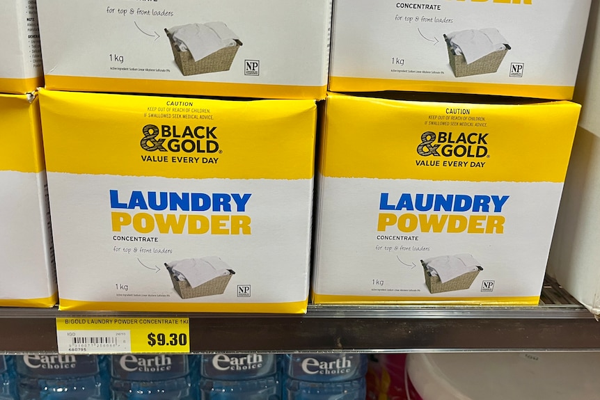 Boxes of Black and Gold brand laundry powder on a shelf marked $9.30