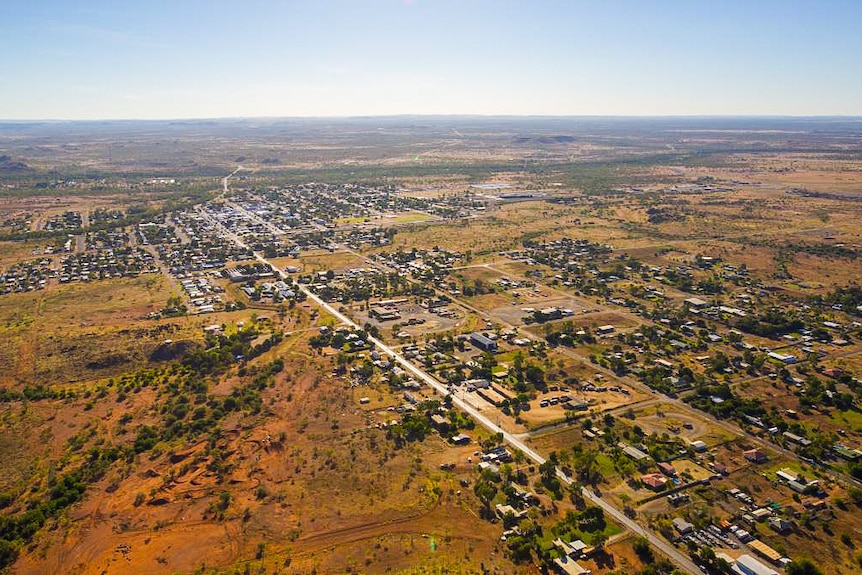 An aerial view of an outback town dotted with small houses.