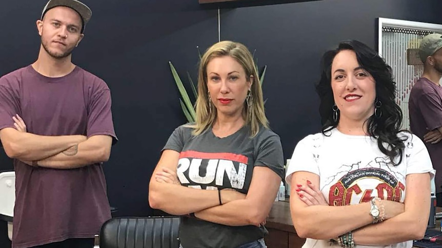 Barbershop owner Joy Arnott with two of her staff in her Darwin premise.