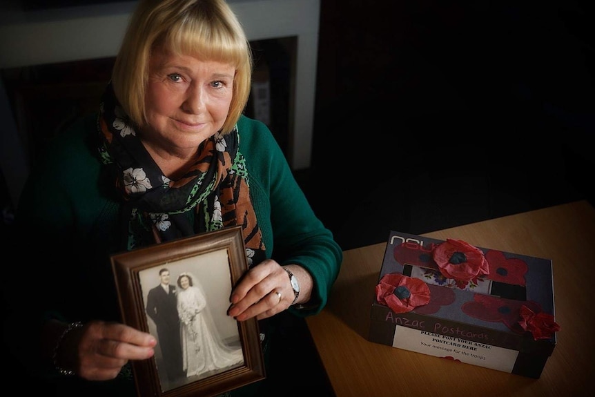 Carmel Torenius holding her parents' wedding photo.