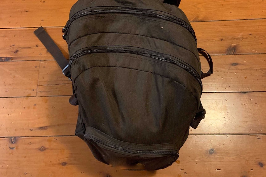 A black backpack on the ground.