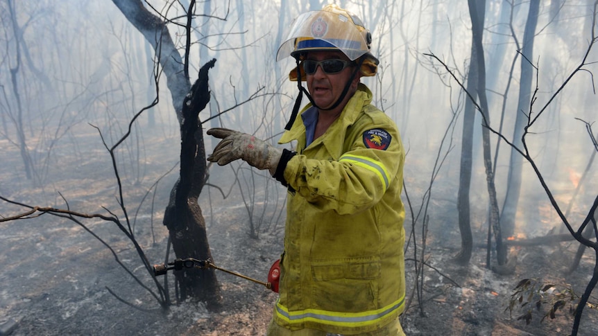 Up to a dozen fire crews are maintaining containment lines on Bribie Island and residents near White Patch Esplanade are urged to remain vigilant.