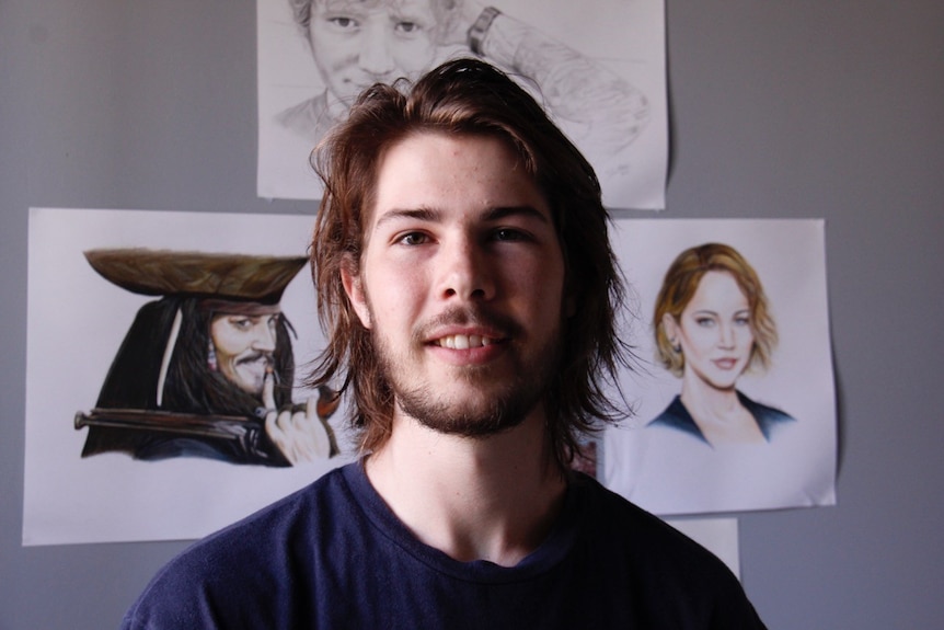 Shaun Minkhorst with pictures of celebrities on the wall behind him.