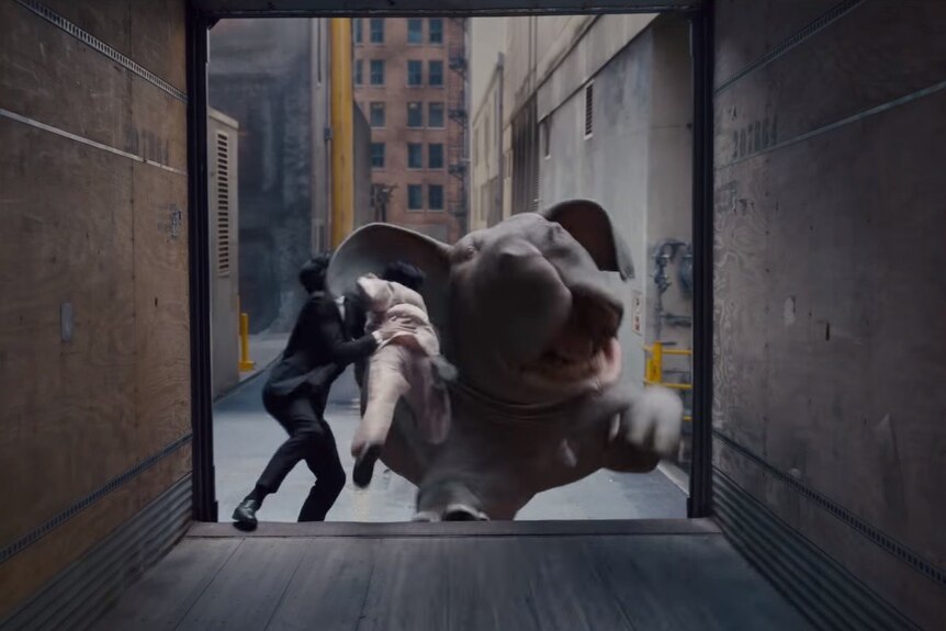 Action and fight sequence between two human characters and Okja in a city alleyway