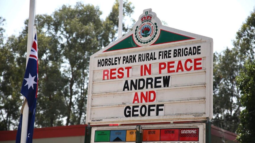 A sign says 'Rest in Peace Andrew and Geoff'