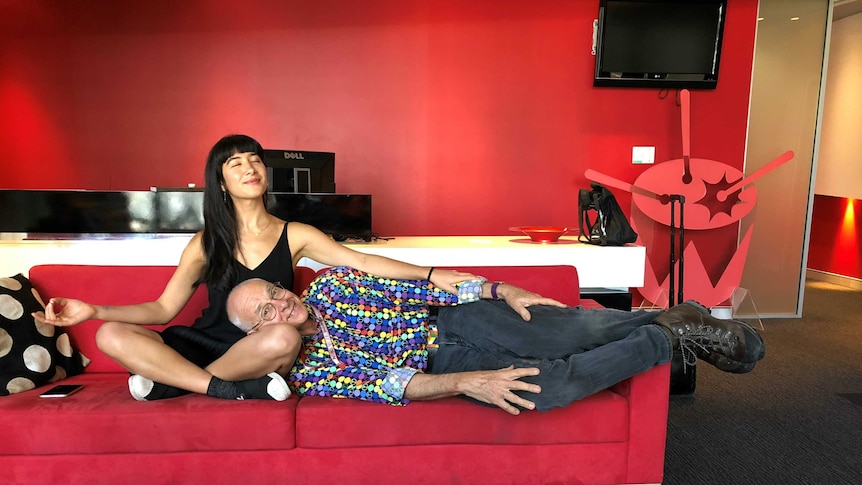 Dr Karl lying on the couch with Linda in a meditative pose