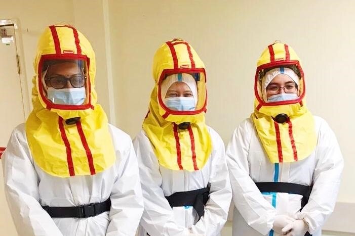 Three Muslim doctors in full PPE.