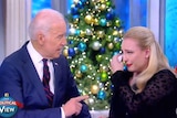 Joe Biden and Meghan McCain on The View. Biden sits next to McCain, McCain is holding a tissue to her eye and is crying