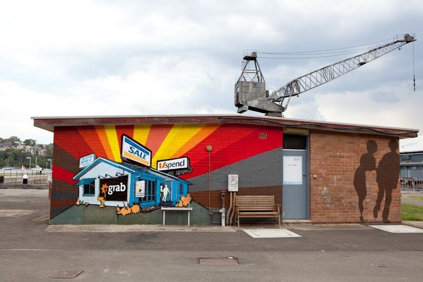 A painting by artist Mini Graff adorns a building on Sydney's Cockatoo Island as part of the Outpost street art festival.