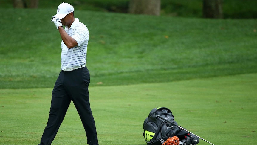 Tiger Woods reacts after missing shot