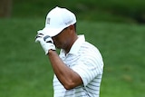 Tiger Woods reacts after missing shot