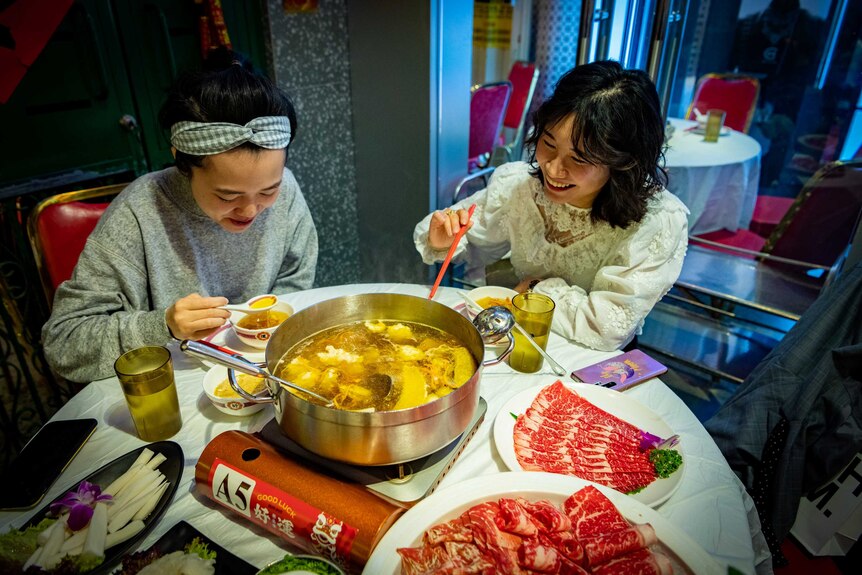 Friends gather for their first hot pot in public in months.