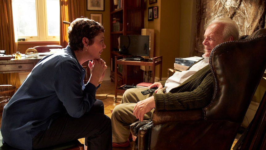 Olivia Colman and Anthony Hopkins talking in a lounge in The Father