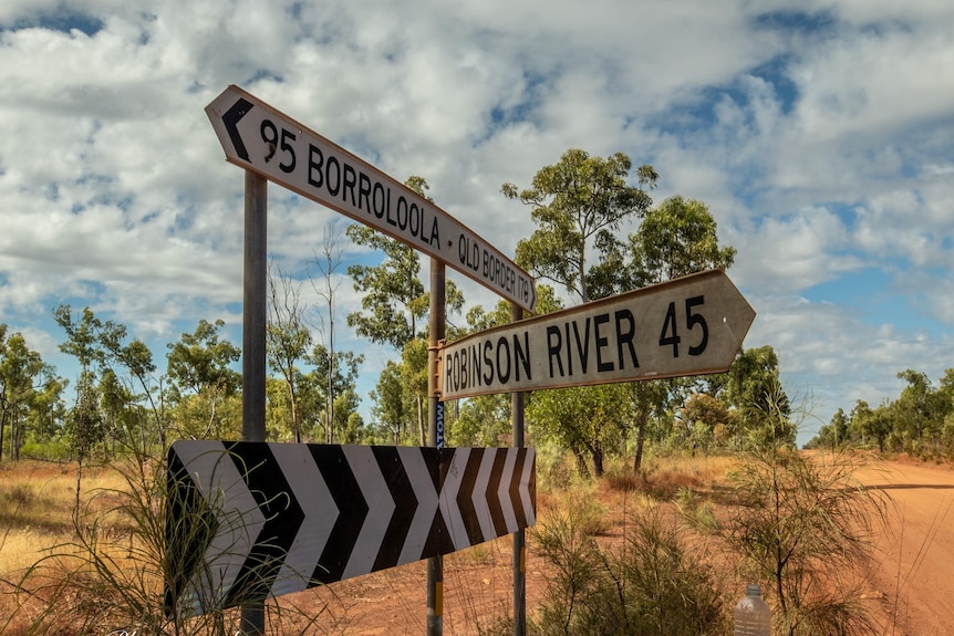 Road signage showing the way to Robinson River, Borroloola and the Queensland border. 