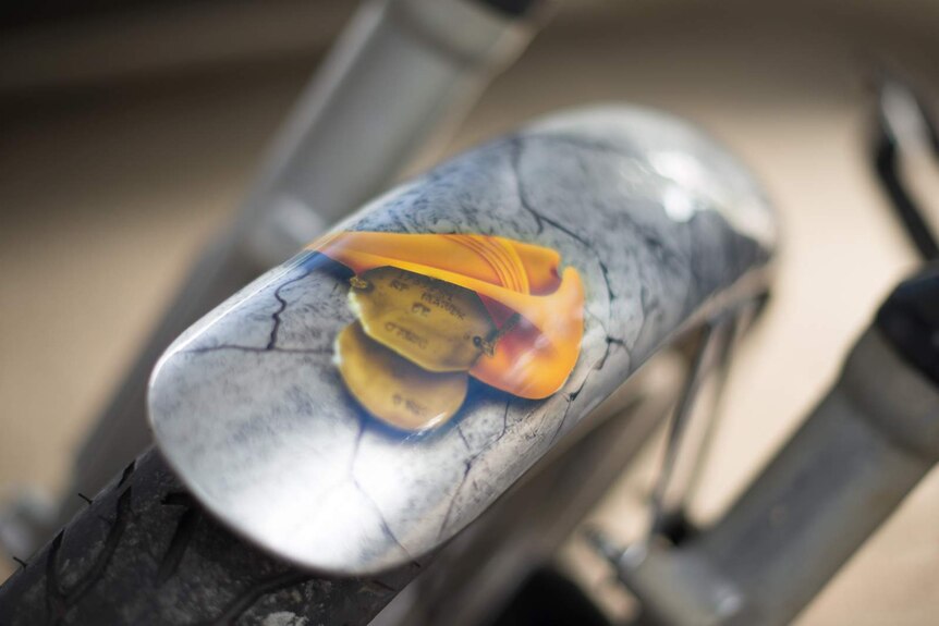 Shorty's dog tags, along with a diggers' slouch hat, is features on the front fender of Shorty's motorcycle.