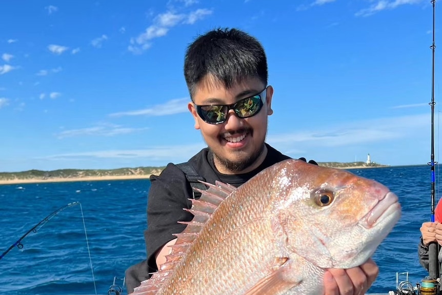 man holds a big snapper