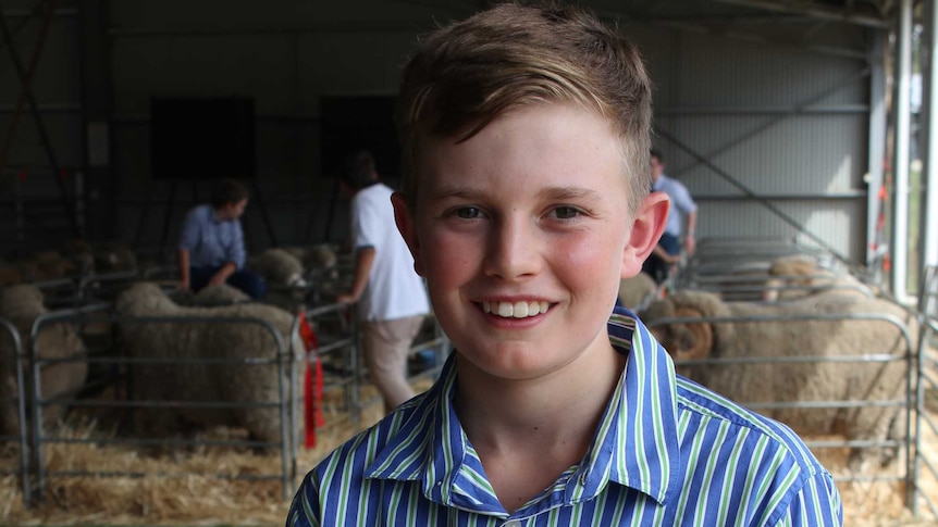 Joe Carlyon stands in the sheep judging ring.