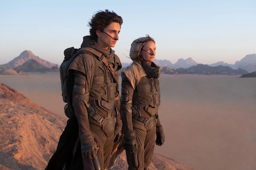 A man and a woman standing on top of a mountain in a new movie called Dune.