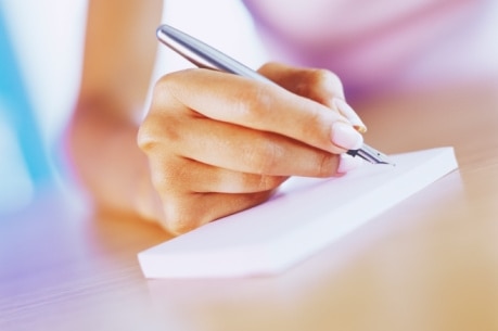 Close-up of woman writing with pen. (Thinkstock: Jupiterimages)
