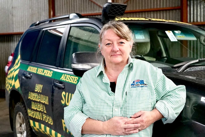 Lyndy Morris leans on a car