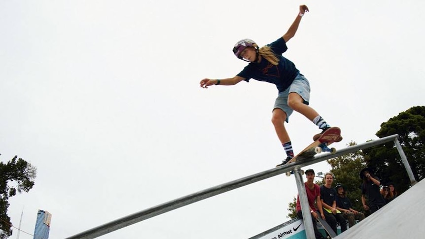 Hayley Wilson balances her skateboard in a rail during a competition.