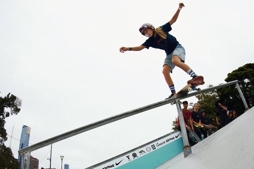 Hayley Wilson balances her skateboard in a rail during a competition.