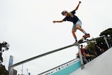 Hayley Wilson balances her skateboard in a rail during a competition.