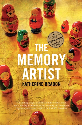 The book cover of the The Memory Artist by Katherine Brabon, a collection of babushka dolls on a map