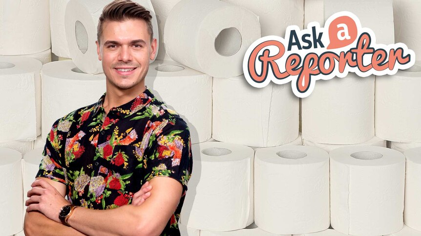 Jack stands in front of a background of stacked toilet rolls.