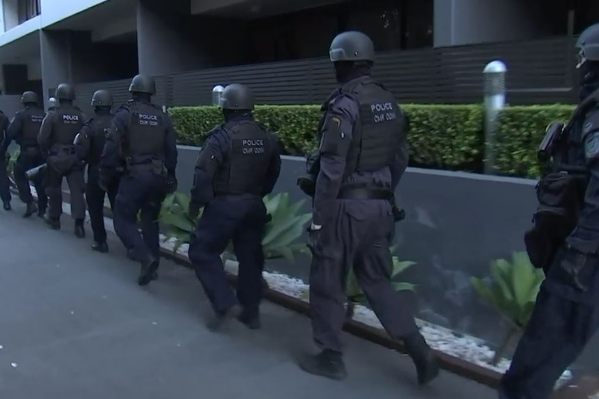 Police officers outside a unit block